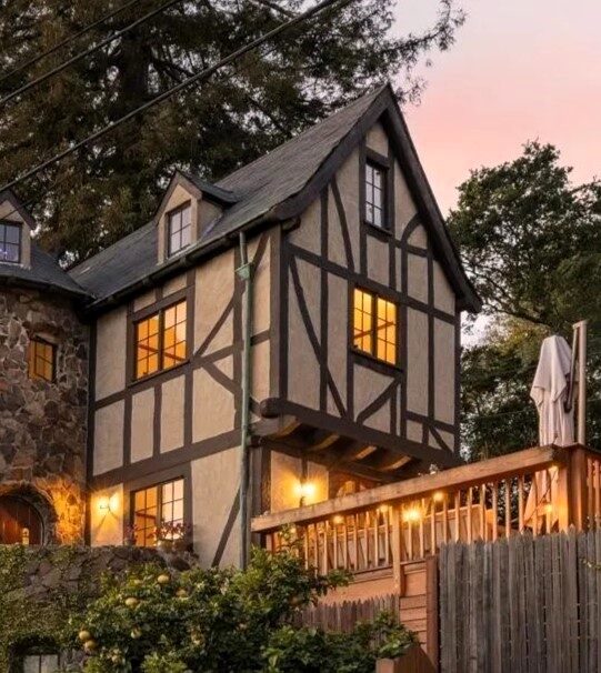 Tudor house exterior with timber framing and soft evening lights, remodeled by a residential designer in Berkeley, CA