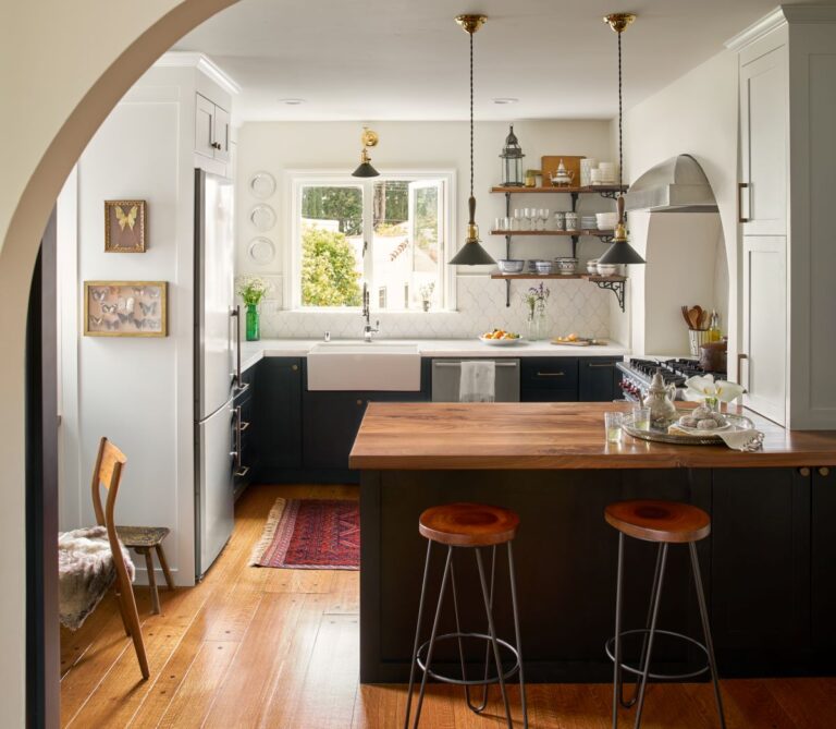 Open kitchen design with wood countertop and modern lighting fixtures in SF