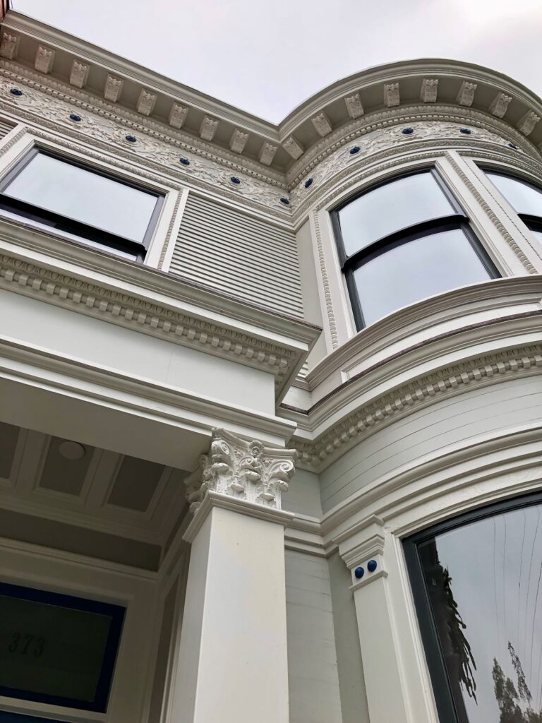 Victorian entryway restoration featuring ornate columns and intricate detailing